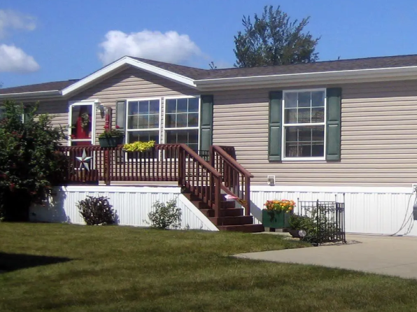 A house with a porch and steps leading to the front door.