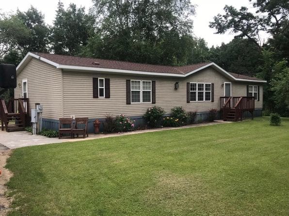 A large house with a lawn in front of it