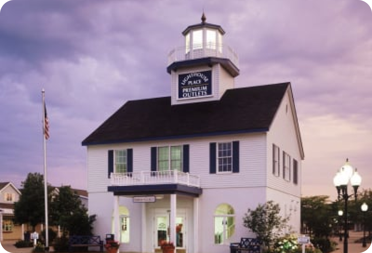 A white building with a clock tower on top of it.