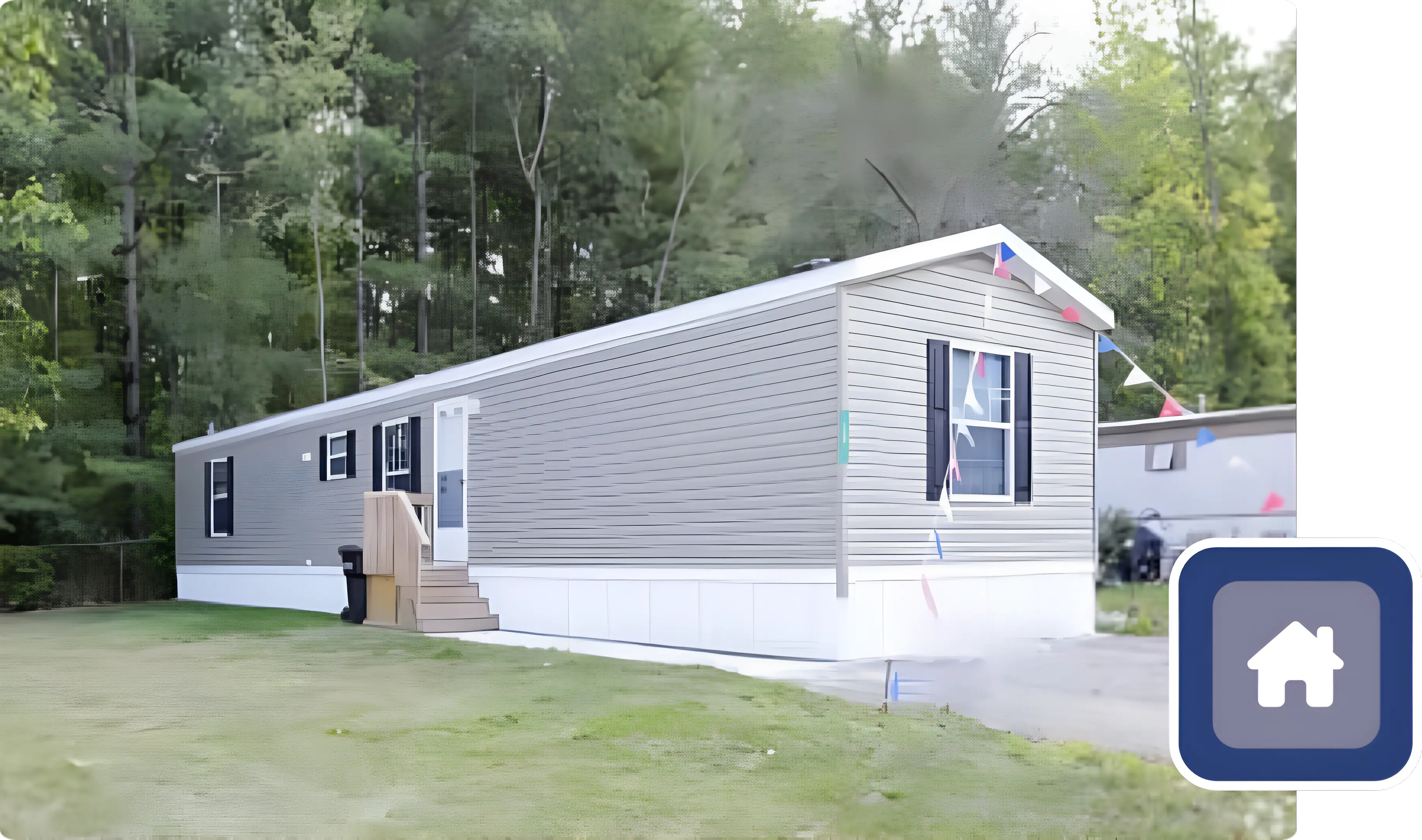 A mobile home with stairs leading to the front door.